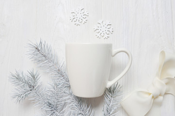 Obraz na płótnie Canvas Mockup white cup on a wooden background, in Christmas decorations. The top view is photographed