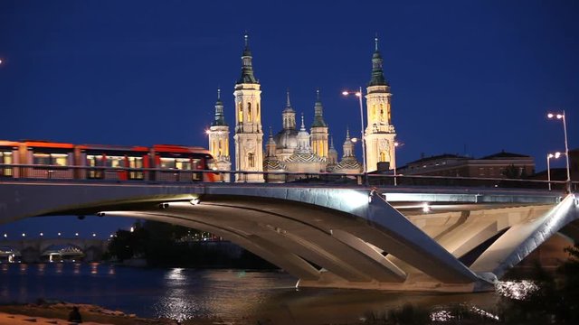 Night view of the modern bridge and ancient Pilar Cathedral in Zaragoza, Spain
