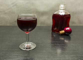 A glass of red wine on the table.