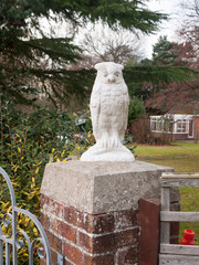 close up white owl statue ornament front drive