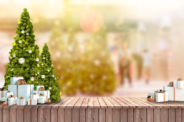 Christmas trees and white gifts box on wooden floor and blurred background.