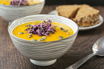 Spicy Squash Soup, gardnished with radish sprouts and pumpkin seeds