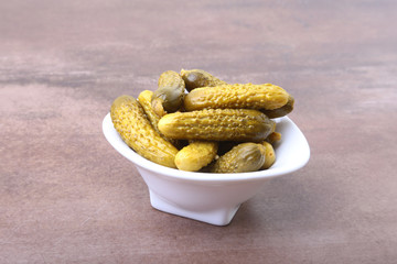 Pickles. Bowl of pickled gherkins cucumber with copy space. Cornichons.