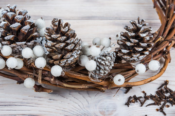 Obraz na płótnie Canvas Christmas wreath on a white wooden background