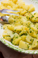 Side dish of boiled potatoes with parsley