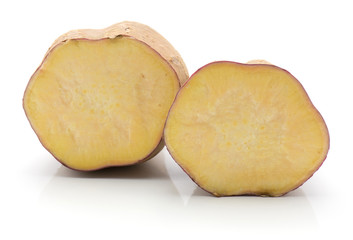 Two sweet potato halves isolated on white background.