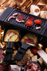 Delicious traditional Swiss melted raclette cheese on diced boiled or baked potato served in individual skillets.