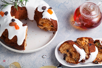 Slices of traditional christmas cake with dried fruits soaked in rum and sugar glaze. Christmas background with festive decoration.