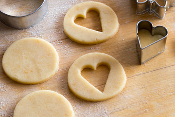 Cutting out pastry shapes for traditional Linzer Christmas cookies