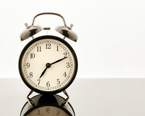An old alarm clock on a white background