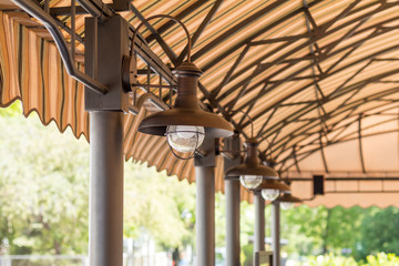 Streetlights under the summer cafeteria canopy. Architectural composition