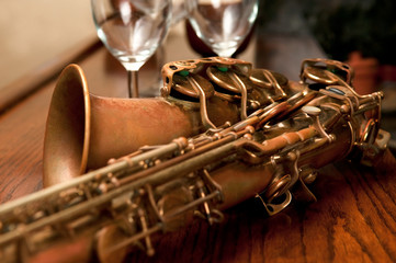 Cropped Shot of Saxophone and Wine Glasses
