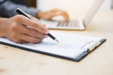 Business team working on laptop, while sitting at office. Business people.