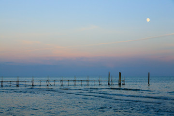 Beach landscape at dawn with moon