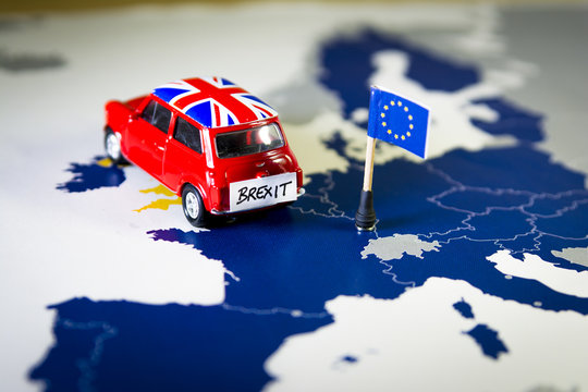 Red vintage car with Union Jack flag and brexit or bye words over an UE map and flag.
