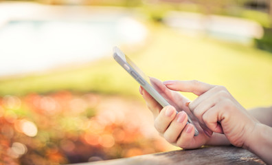 Female hands using smart phone.