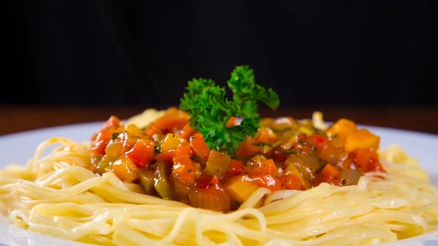 pasta in plate with vegetable sauce and parsley