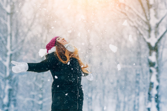 Winter young woman portrait. Beauty Joyful Model Girl laughing and having fun in winter park. Beautiful young woman outdoors. Enjoying nature, wintertime