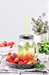 Lemonade in jars, on the kitchen table at home