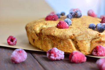 Appetizing pie with berries. A piece of very tasty home-made pie. Charlotte with apples, decorated with berries.