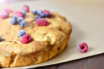 Appetizing pie with berries. A piece of very tasty home-made pie. Charlotte with apples, decorated with berries.