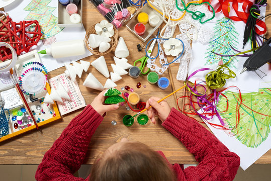 Children make crafts and toys, christmas tree and other. Painting watercolors. Top view. Artwork workplace with creative accessories. Flat lay art tools.