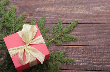 Christmas fir tree with gift boxe on wooden board