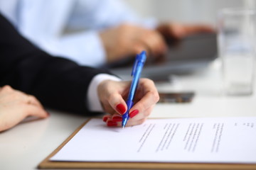 Businesswoman sitting in office, working with laptop computer