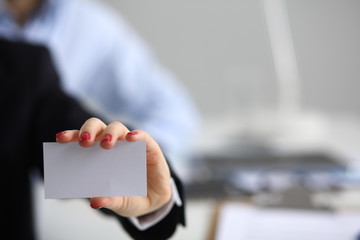 Woman hand giving business card in office