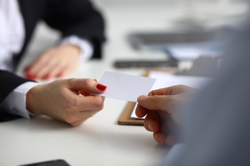 Woman hand giving business card in office