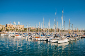 Fototapeta na wymiar Harbor in Barcelona, boats and yachts on turquoise water