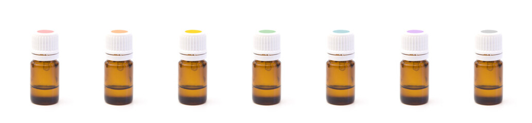 Row of Various Colored Essential Oil Bottles with Rainbow Colored Labels