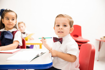 Cute kindergarten pupil in a classroom