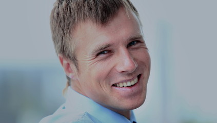 Portrait of smiling young businessman at office.