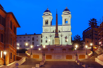 Fototapeta na wymiar Monumental stairway Spanish Steps, seen from Piazza di Spagna, and Trinita dei Monti church during morning blue hour, Rome, Italy.