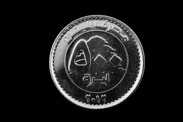 A super macro image of a Lebanese 500 livres coin isolated on a black background