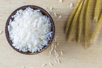 raw white rice in a bowl on wood table, top view