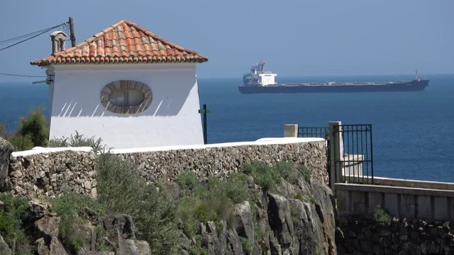 White house by the ocean with ship 
