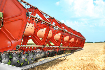 Combine harvester in field