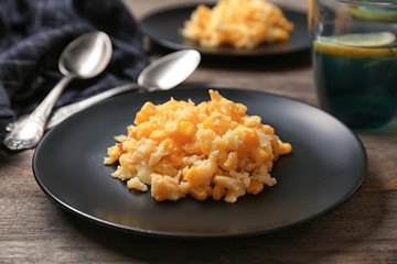 Plate with corn pudding on table