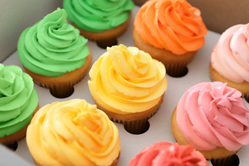 Delicious cupcakes in cardboard package, closeup