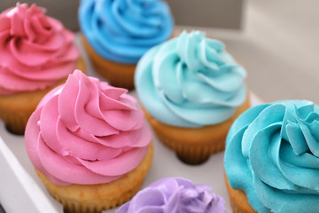 Delicious cupcakes in cardboard package, closeup
