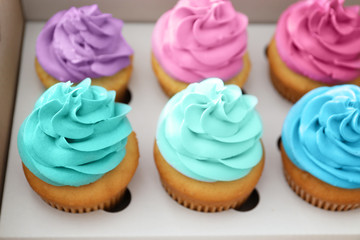Delicious cupcakes in cardboard package, closeup