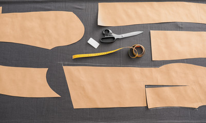 Grey fabric and sewing accessories on table, top view