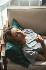 Woman smoking on bed