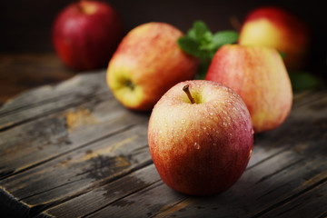 Red sweet apple and the woodan background, selective focus