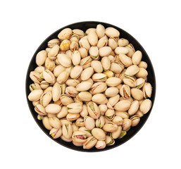 close up of a bowl of pistachio nuts  on white