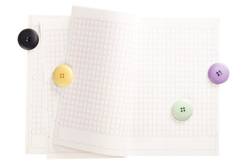 note spread with button isolated on the white background.