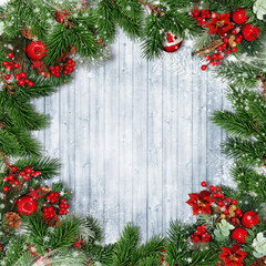 Fototapeta na wymiar Christmas decorations with firtree, holly and Christmas wreath on wooden snowy board