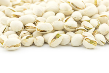 pile of pistachios nuts on white background